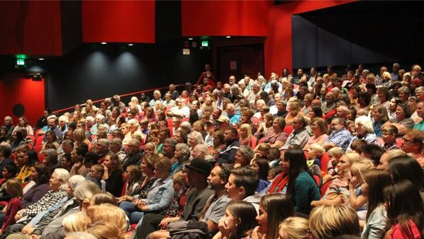 A photo of audience members seated at the PAC.