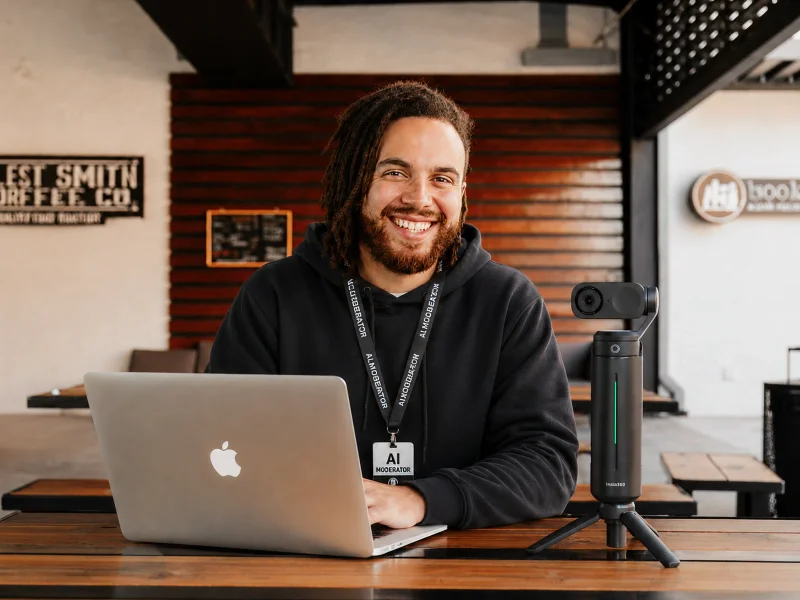 Moderator Image of man behind a computer and a camera