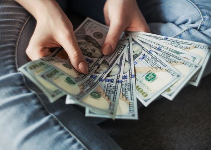 woman showing cash fanned out