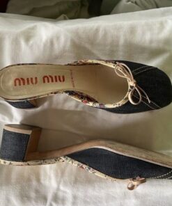 vintage Miu Miu denim mules featuring a floral lining and a small leather bow detail.