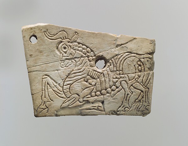 Incised furniture plaque with a kneeling bull