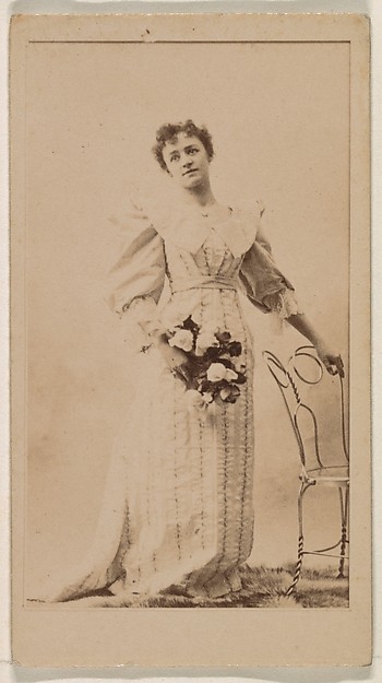 Woman standing with hand on chair, from the Actresses series (N245) issued by Kinney Brothers to promote Sweet Caporal Cigarettes