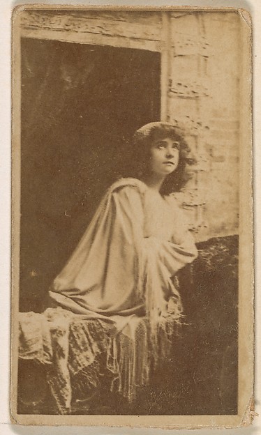 Actress posed in open window, from the Actresses series (N245) issued by Kinney Brothers to promote Sweet Caporal Cigarettes