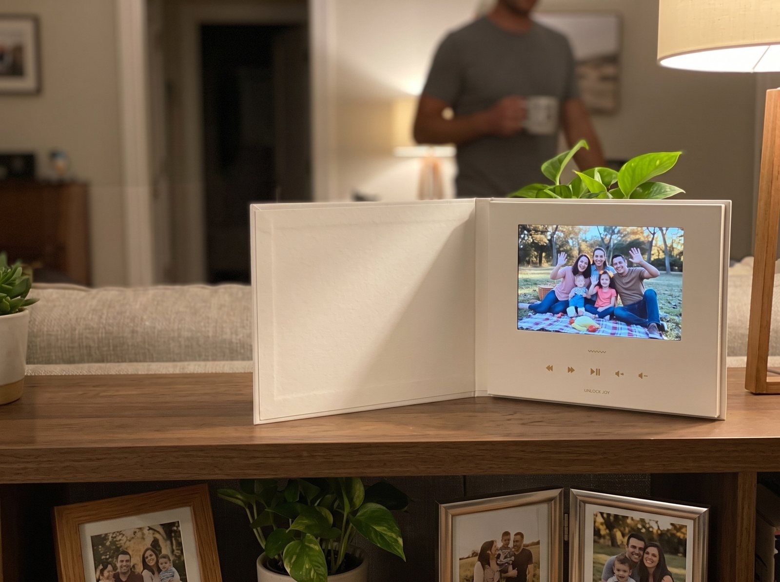 Open Tribute Video Book playing on a living room bookshelf